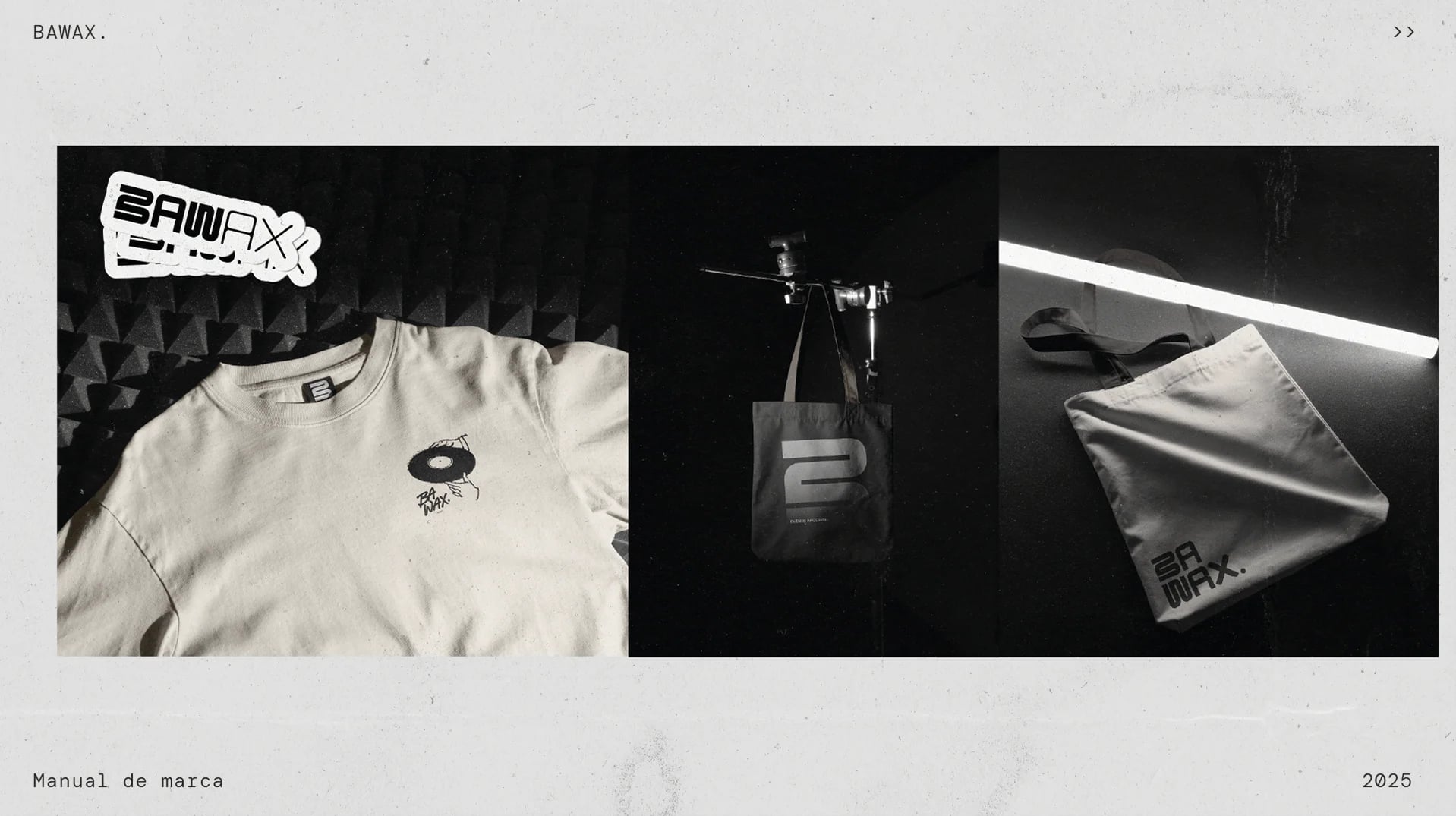 Merchandise in black and white: a T-shirt, a tote bag and a slipmat bag.