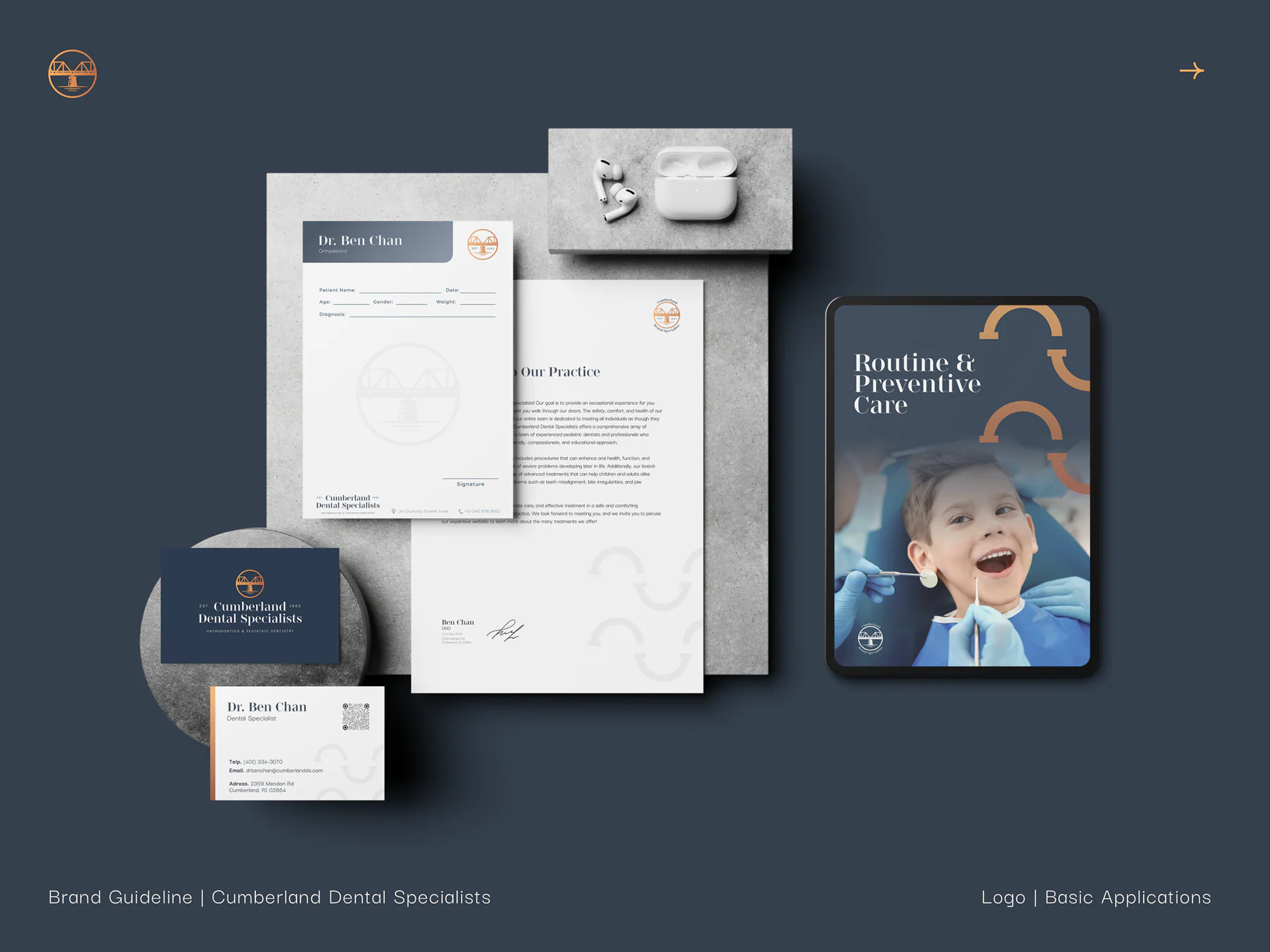 Stationery on navy: letterhead, business cards and a tablet with a child smiling at the dentist.