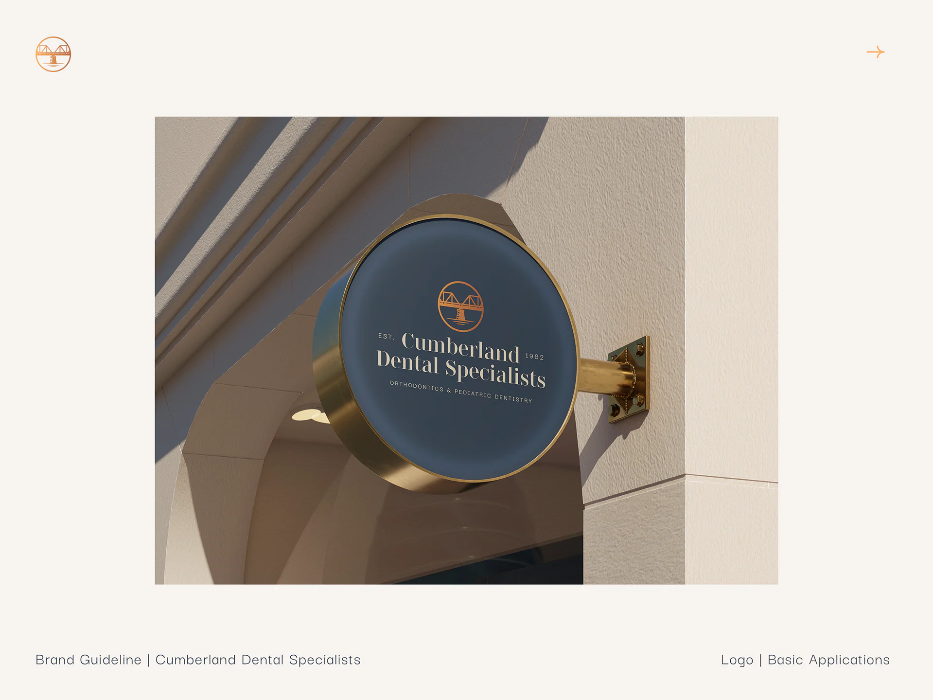 A round navy sign with the logo mounted on a building facade.