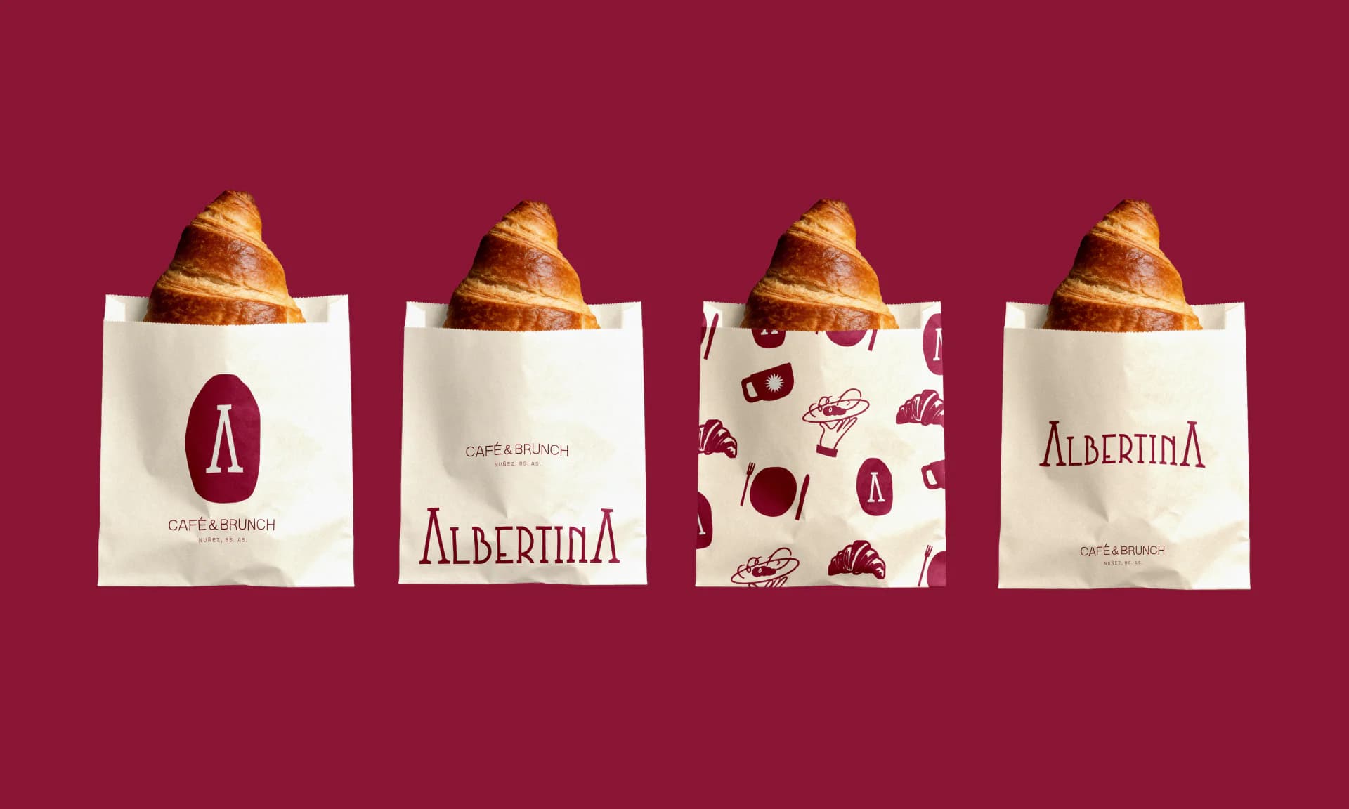 Four paper pastry bags with croissants, each with a different application of the identity, on burgundy.
